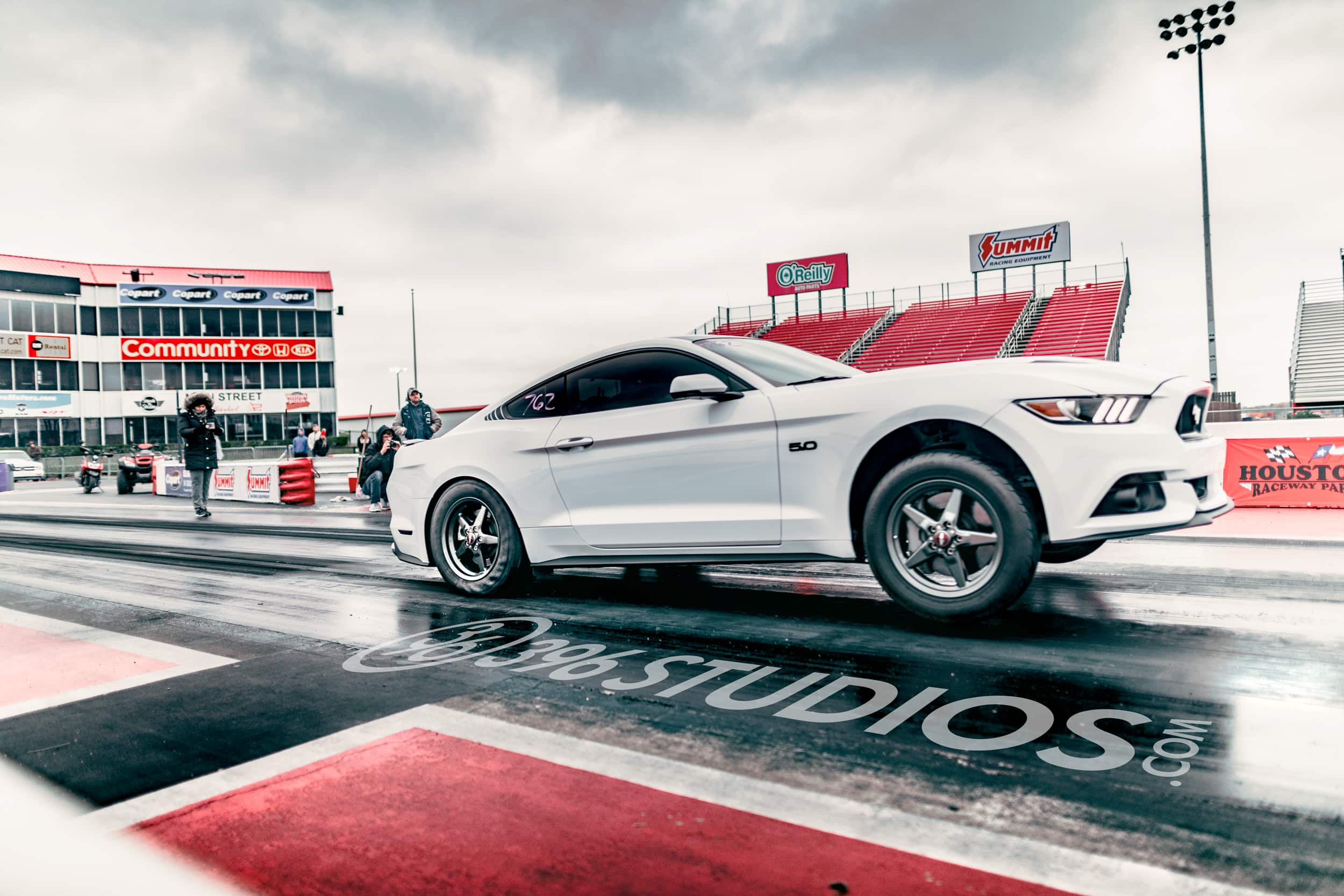 White Mustang launches wheels off ground at a quarter mile track