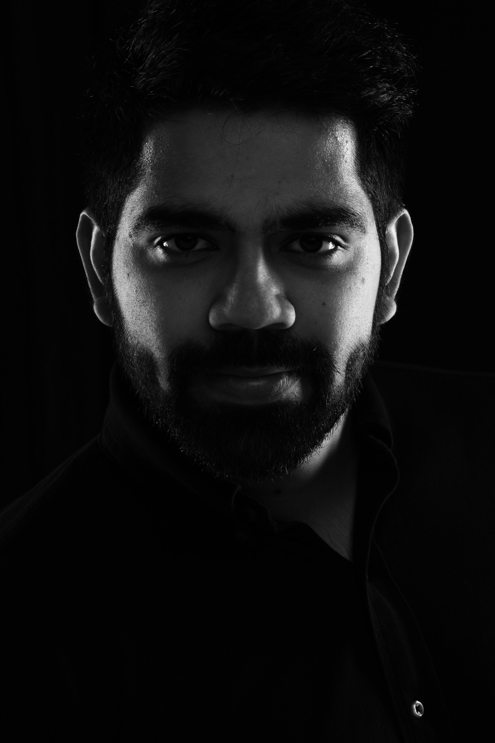 Black and white side lit indian beard headshot