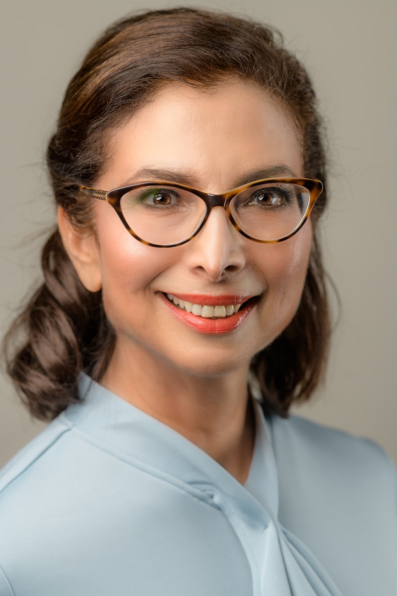 Shushana Castle, author headshot, glasses and brown hair