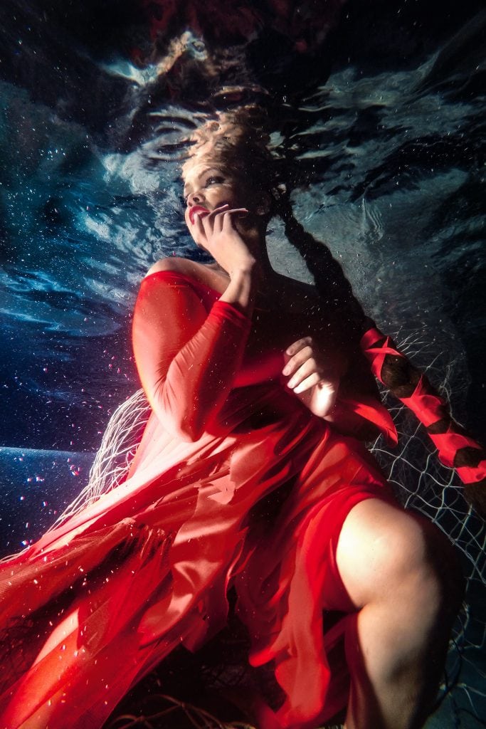 underwater model in red dress stunning portrait