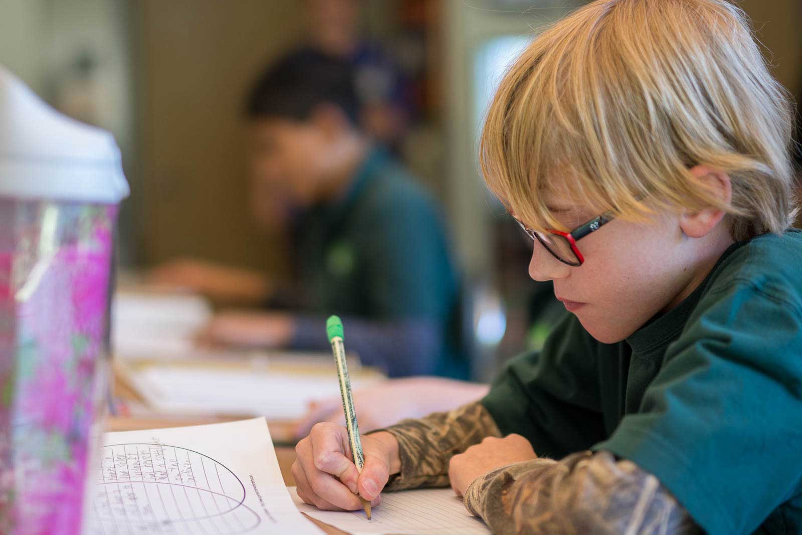 Child takes a test at school, photo used for their brochures