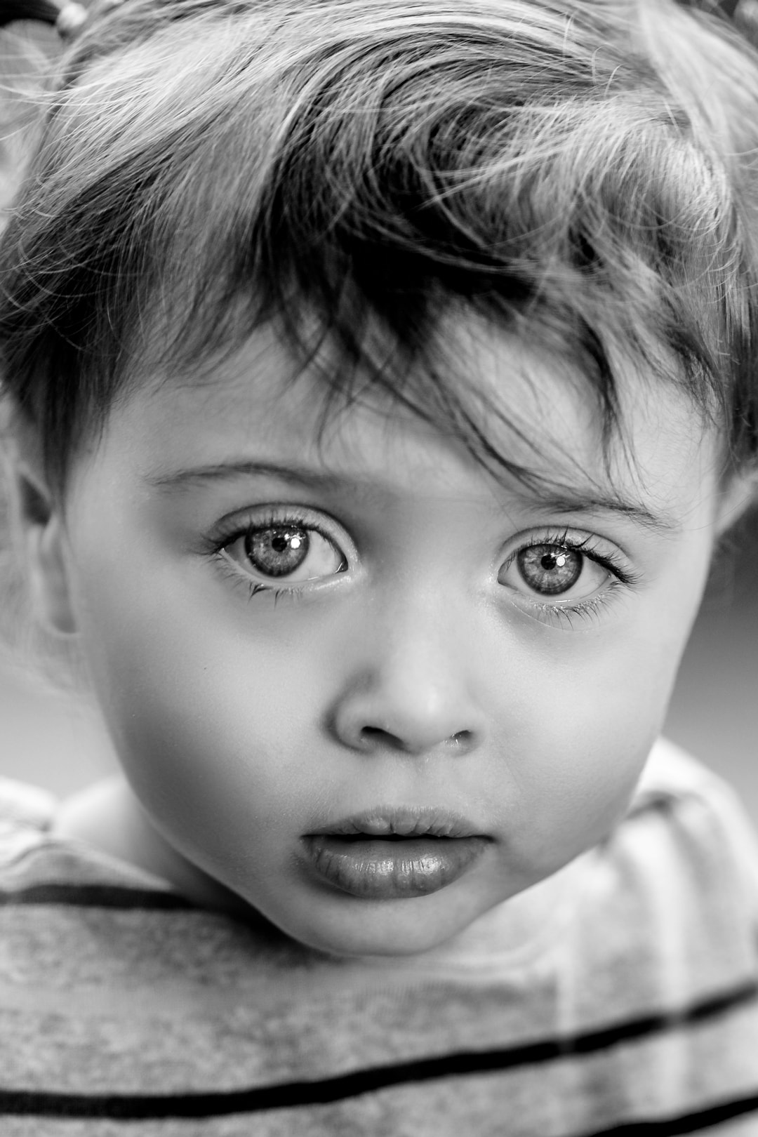 A black and white photo of a little girl.