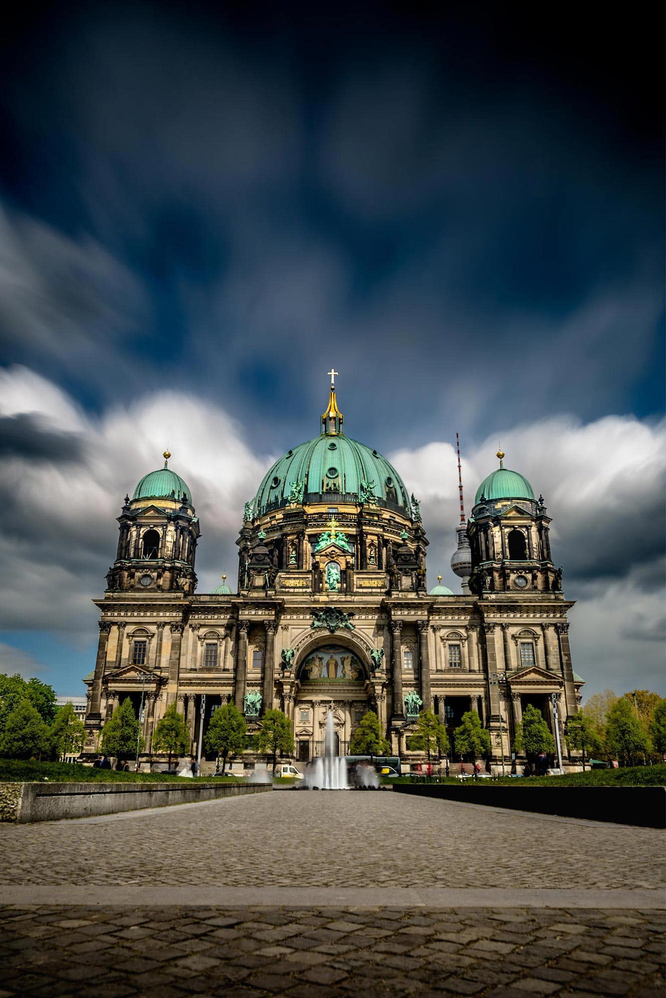 Berlin cathedral under a cloudy sky.