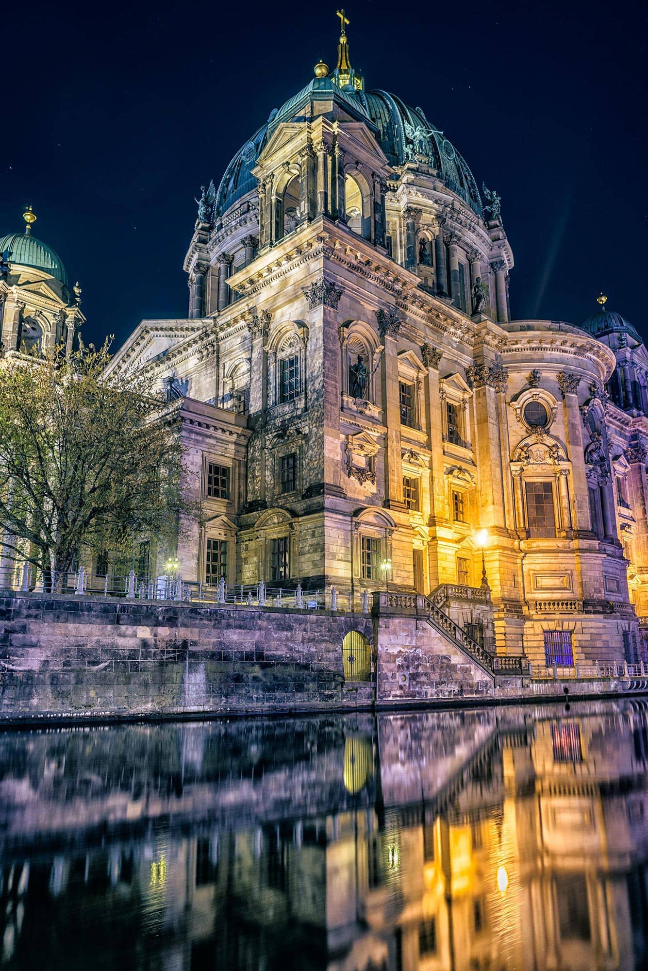 Berlin cathedral reflected in the water at night.