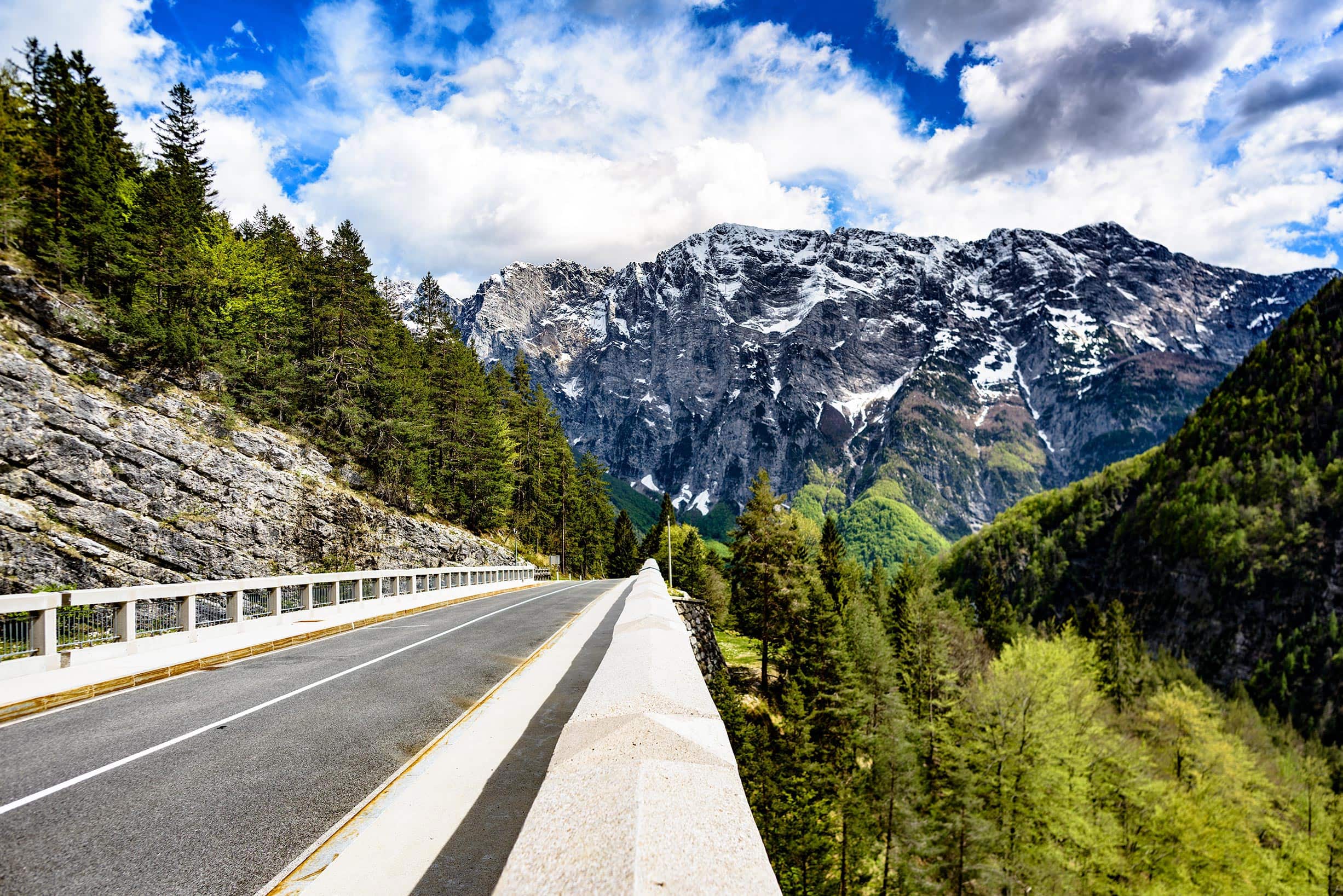 A road in the mountains with mountains in the background.