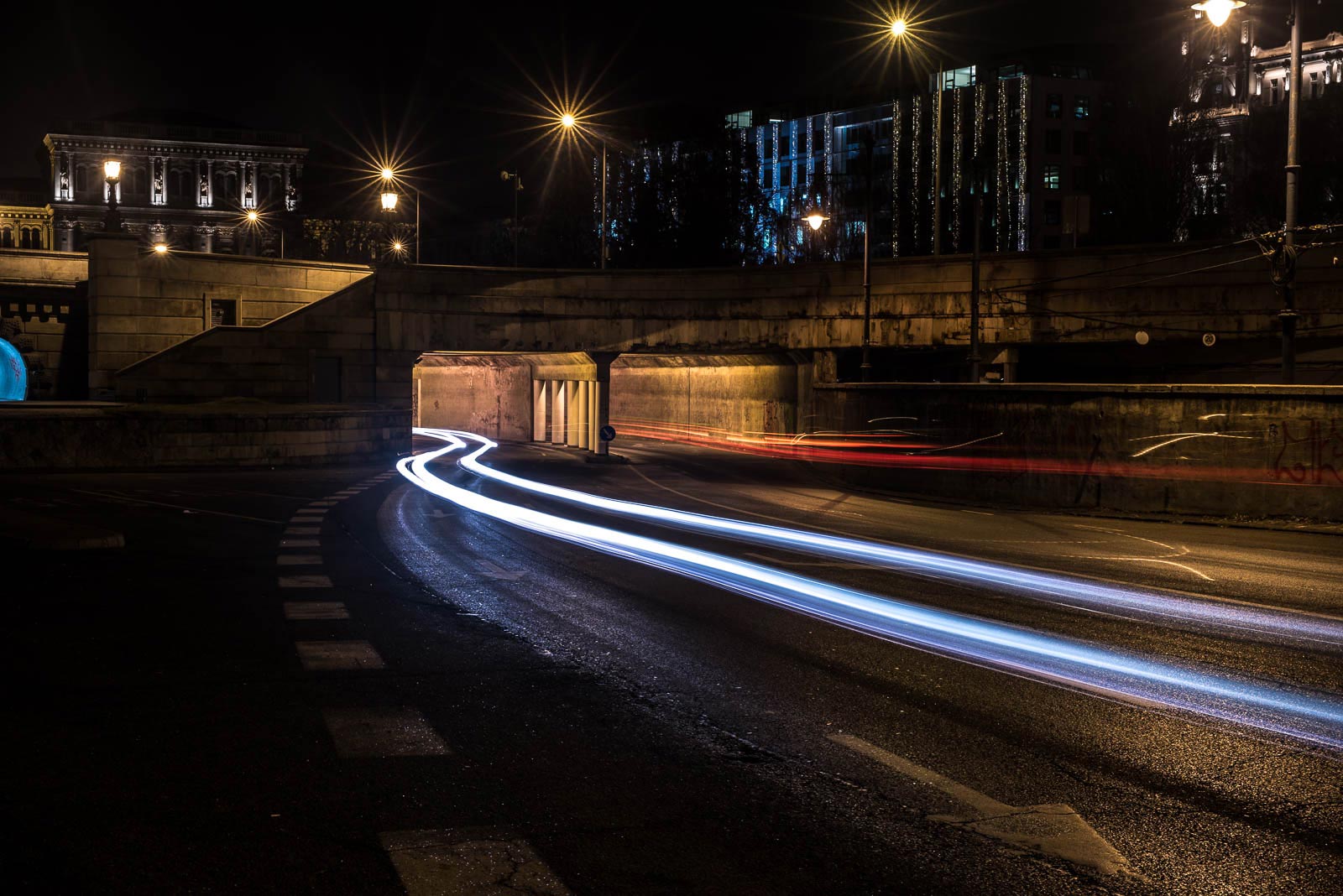 A tunnel under a bridge.