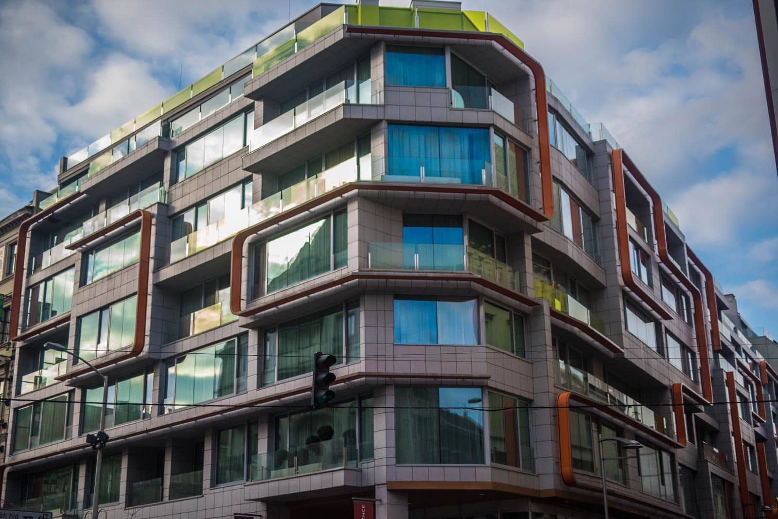 A modern apartment building with balconies and windows.