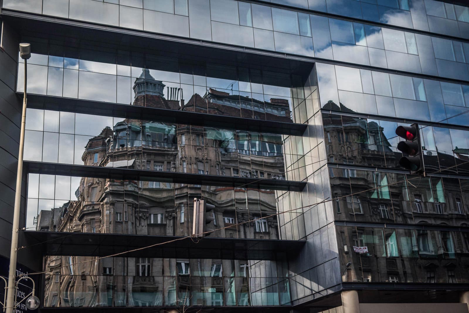 A building is reflected in a glass building.