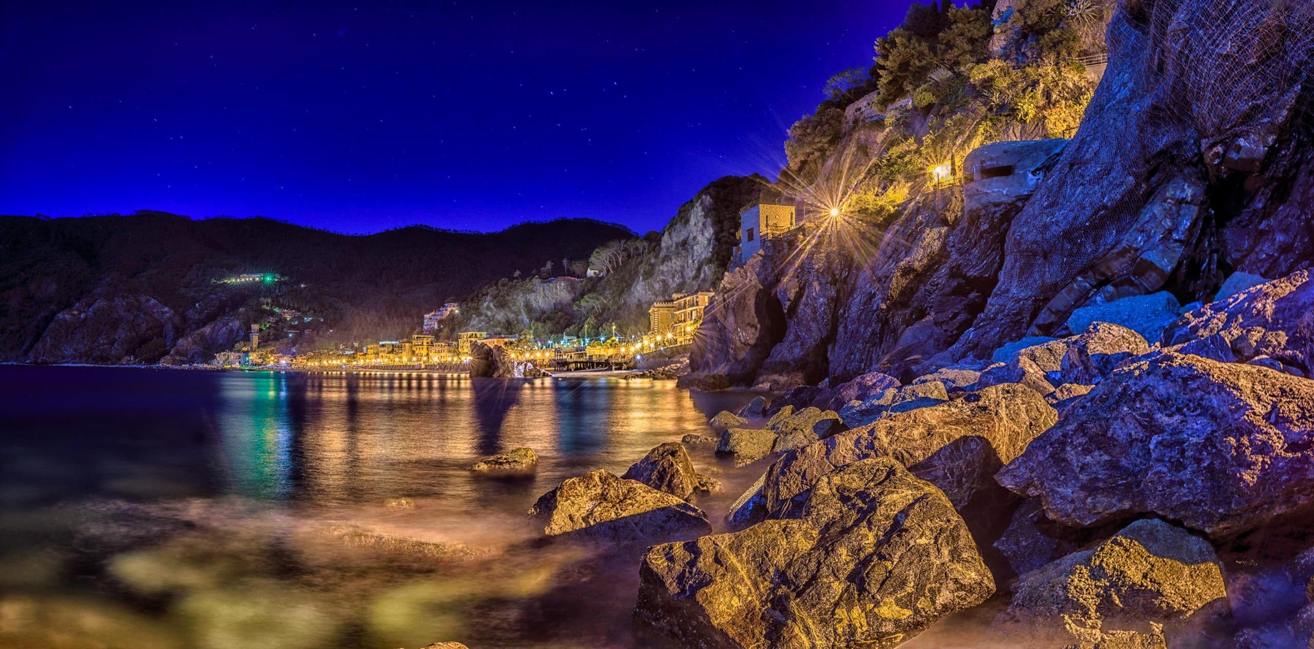 A view of a rocky shore at night.