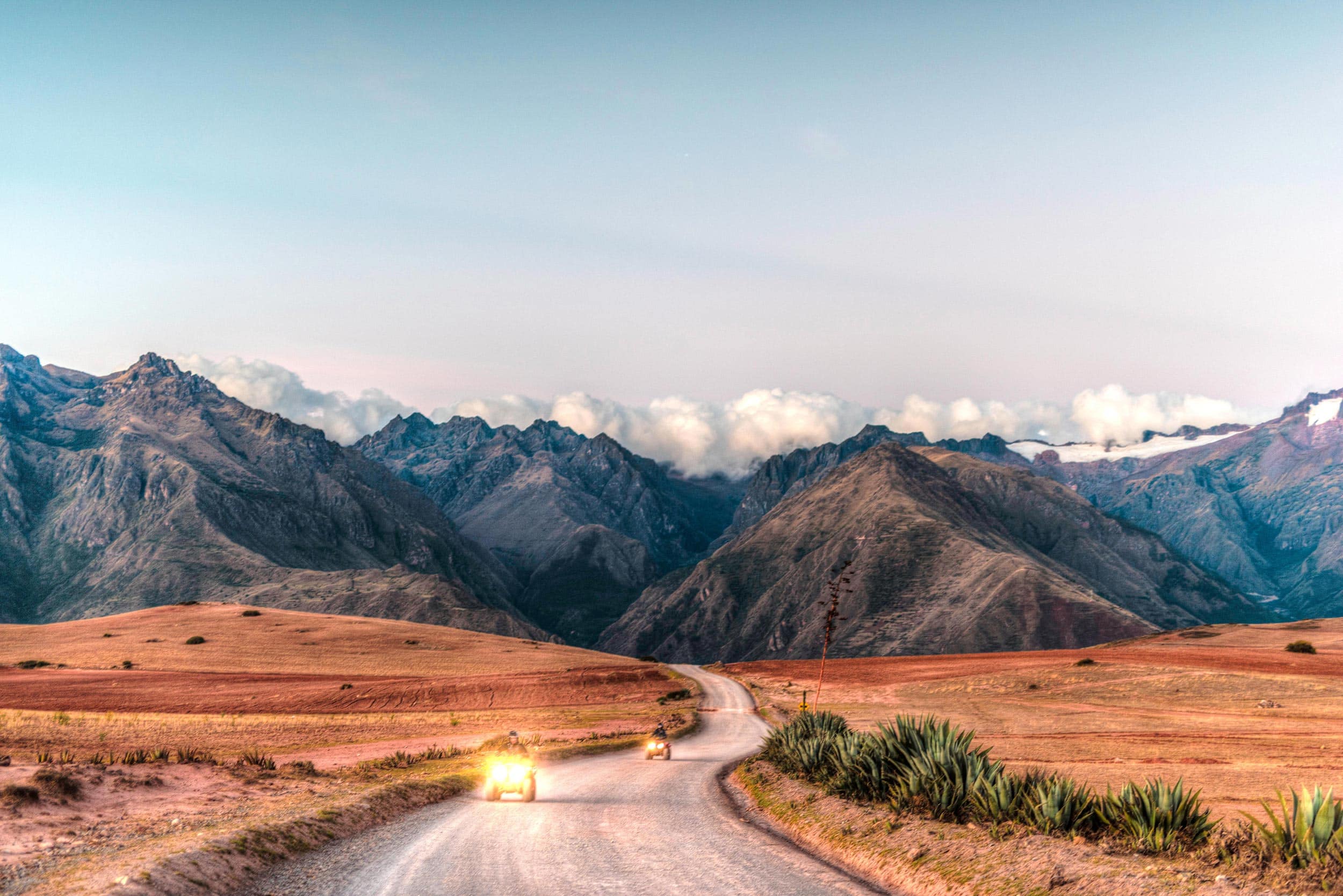 A dirt road with mountains in the background.