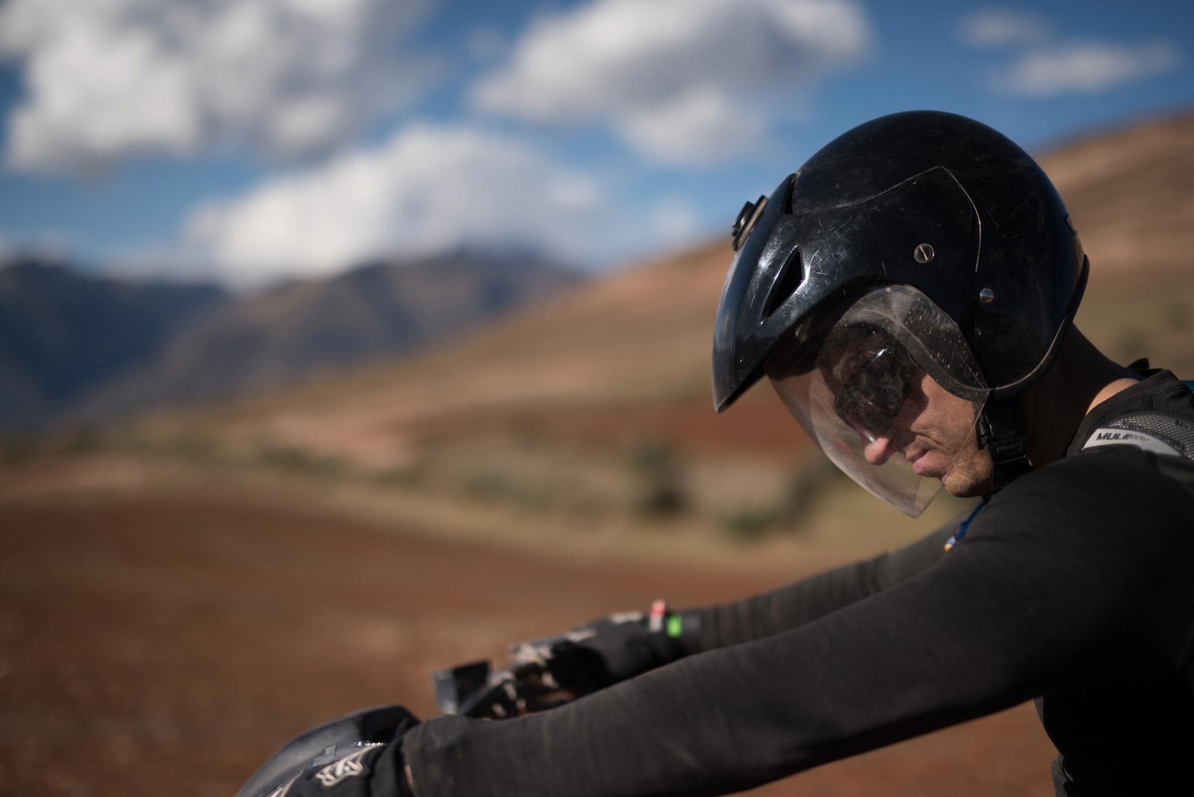 A man wearing a helmet on a motorcycle.