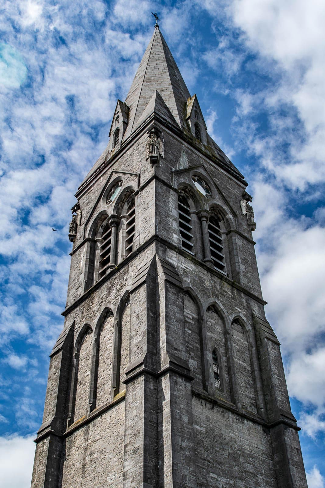 A stone tower with a clock on it.