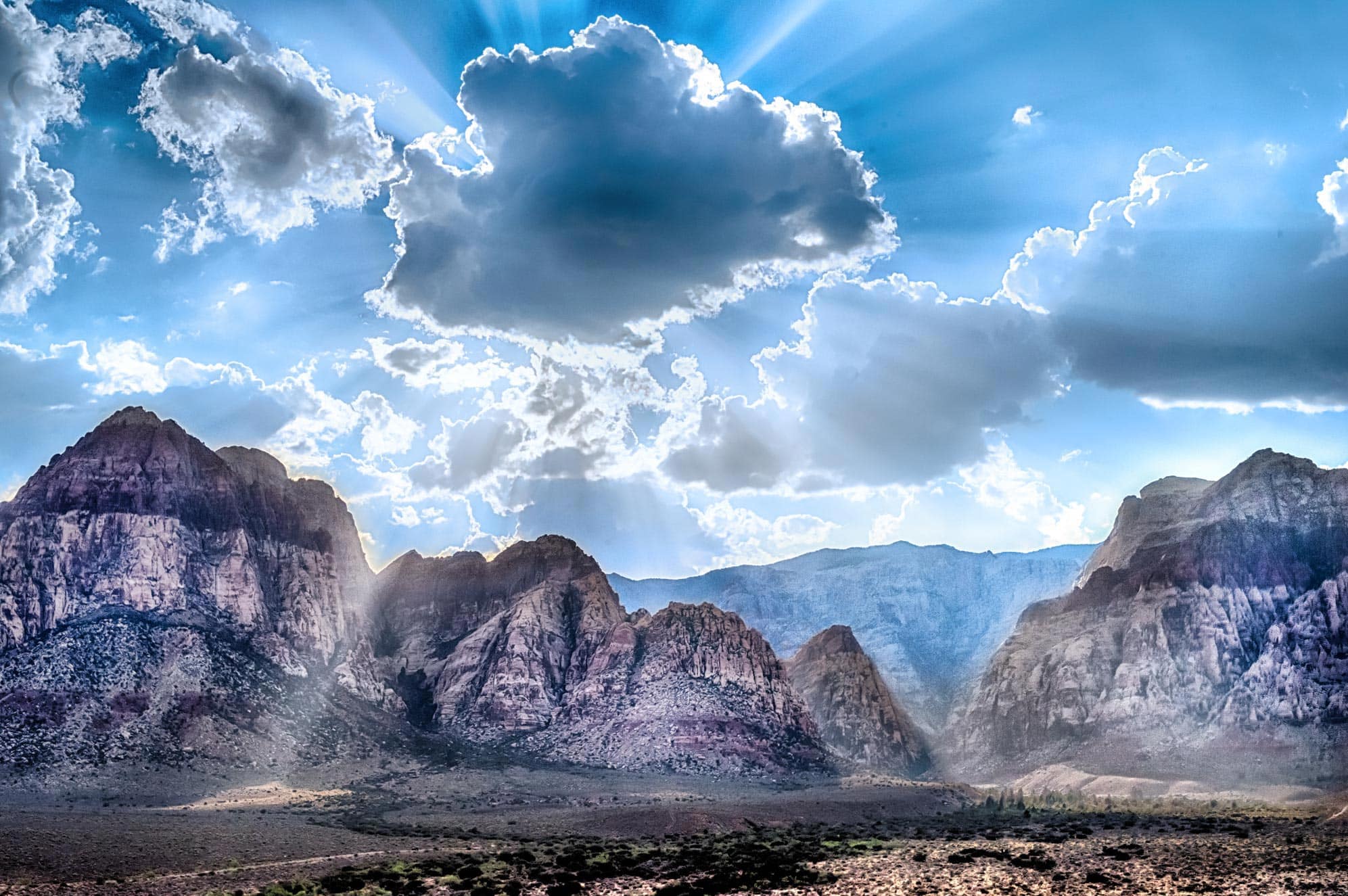 The sun shines through the clouds over the mountains in zion national park, utah, utah, u.