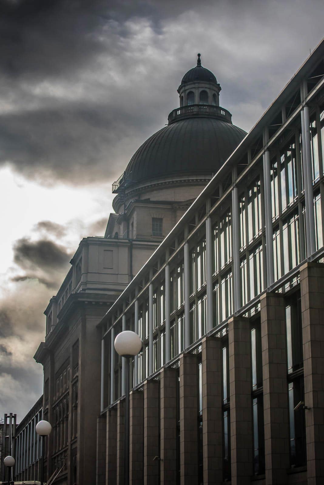 A building with a clock in front of it.