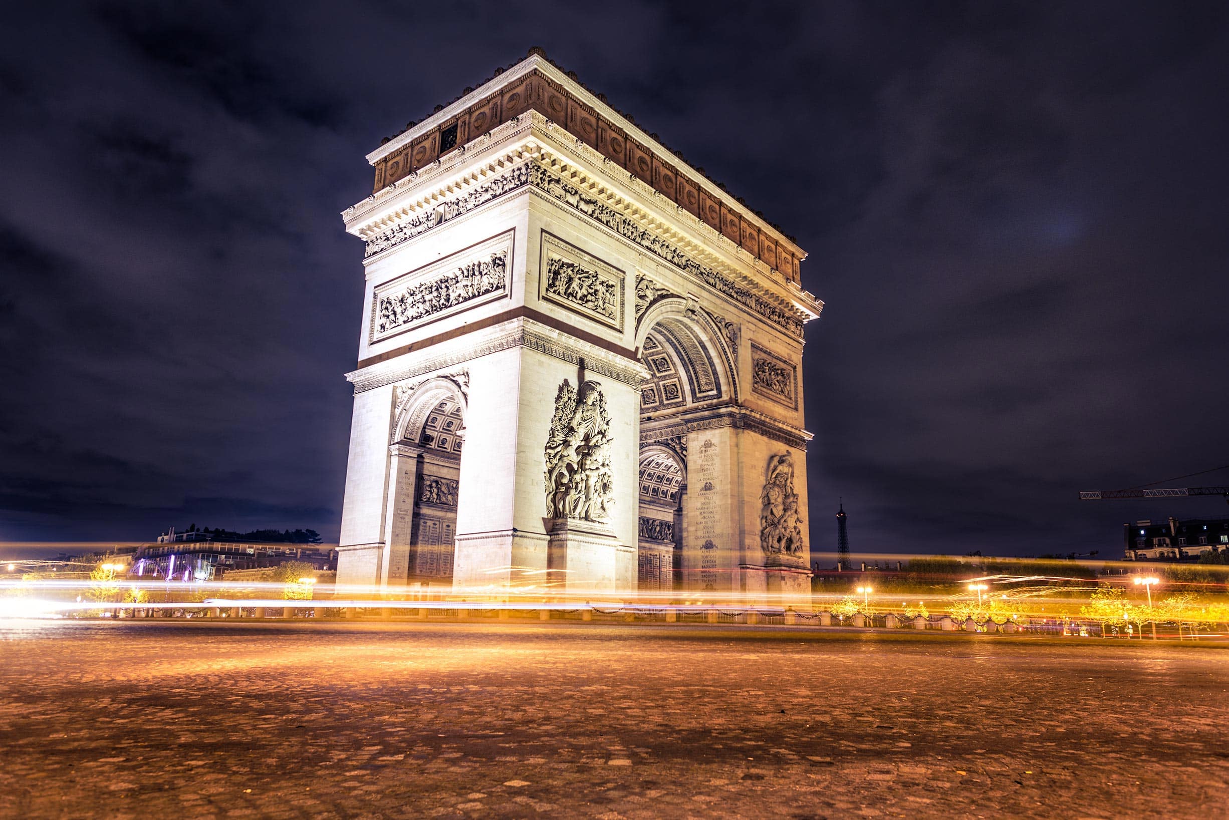 An image of the arc de triomphe at night.