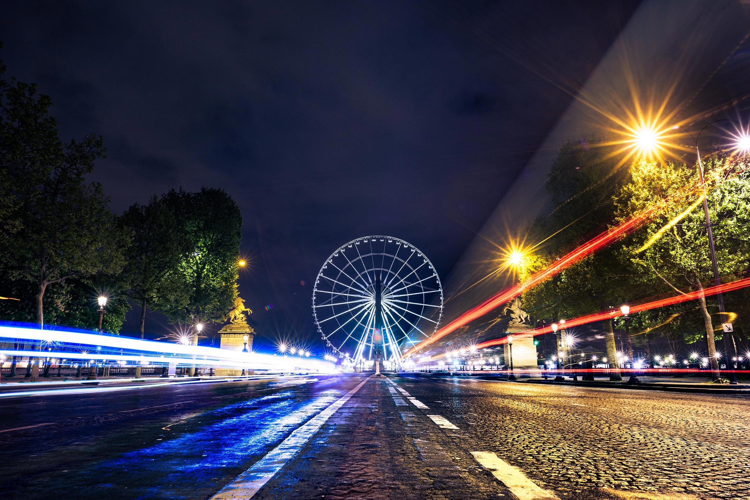 A ferris wheel in a city at night.