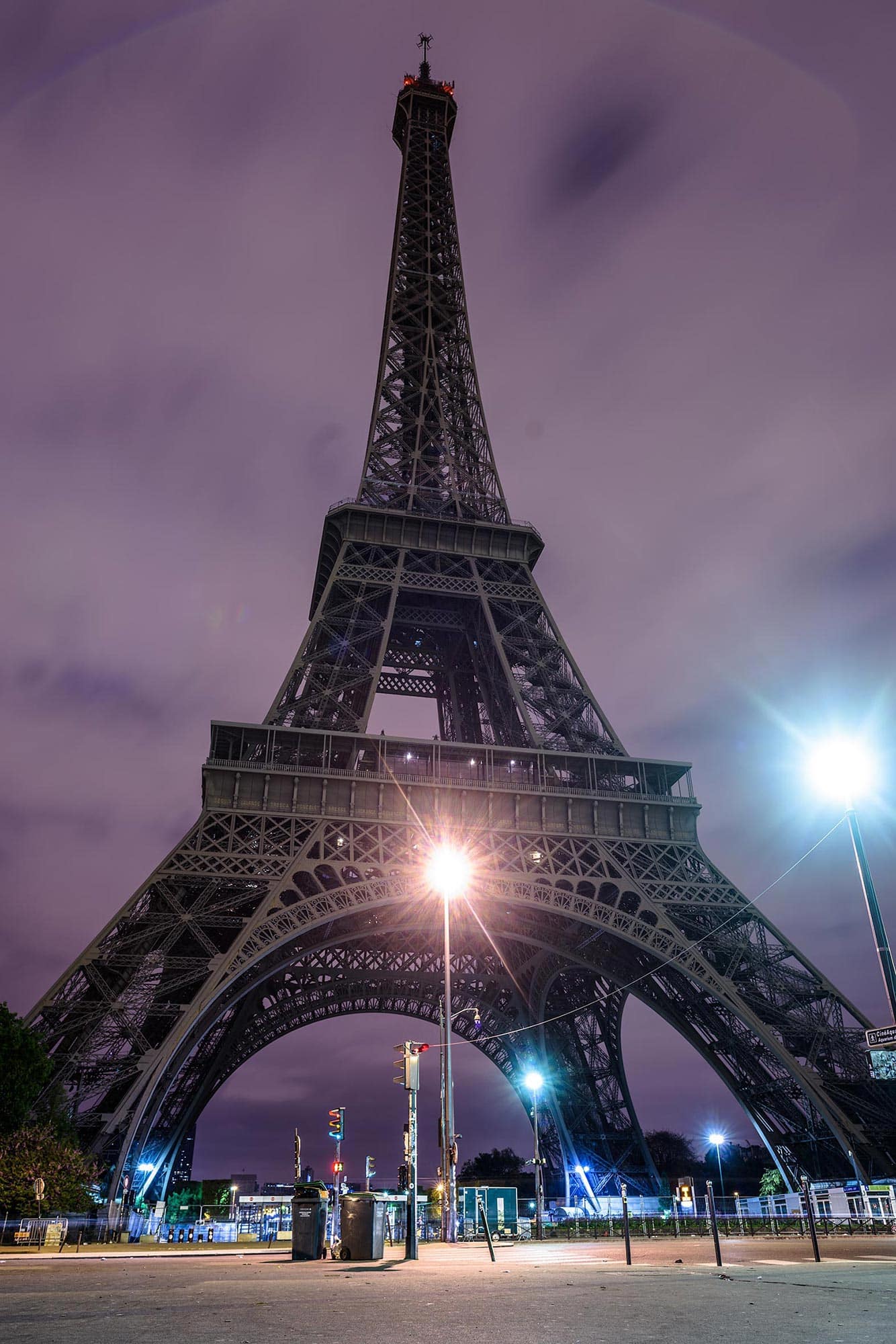 The eiffel tower is lit up at night.