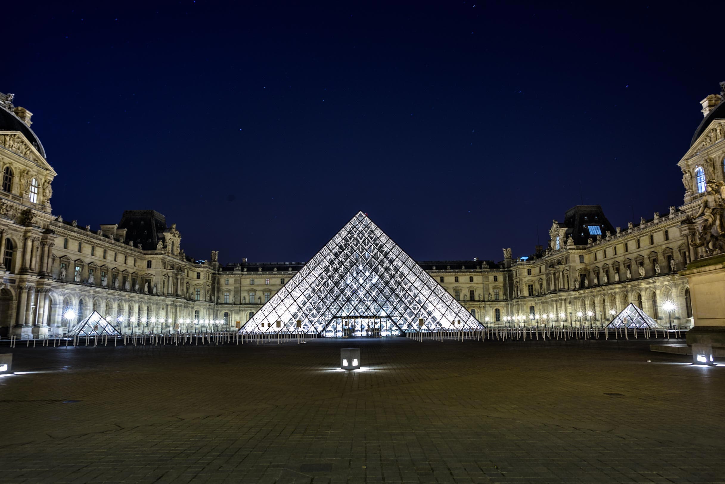 The pyramid of the louvre at night.