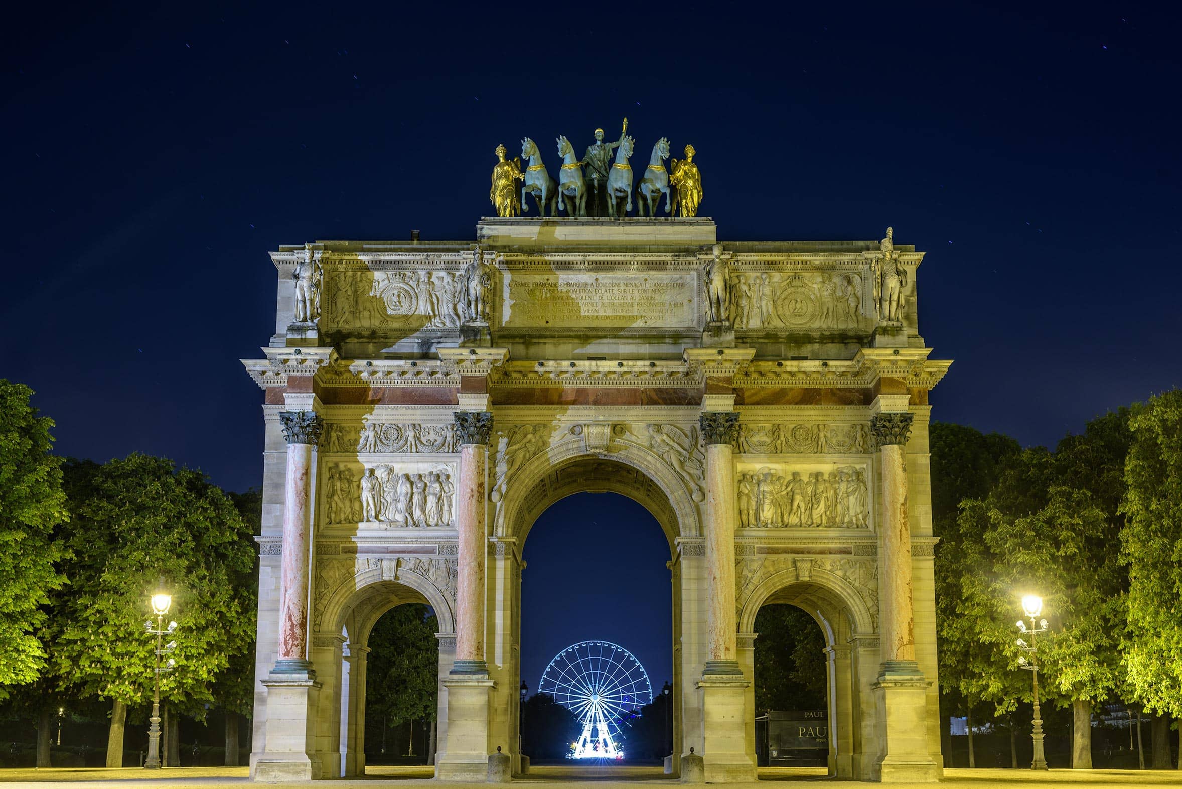 The arc de triomphe in paris at night.