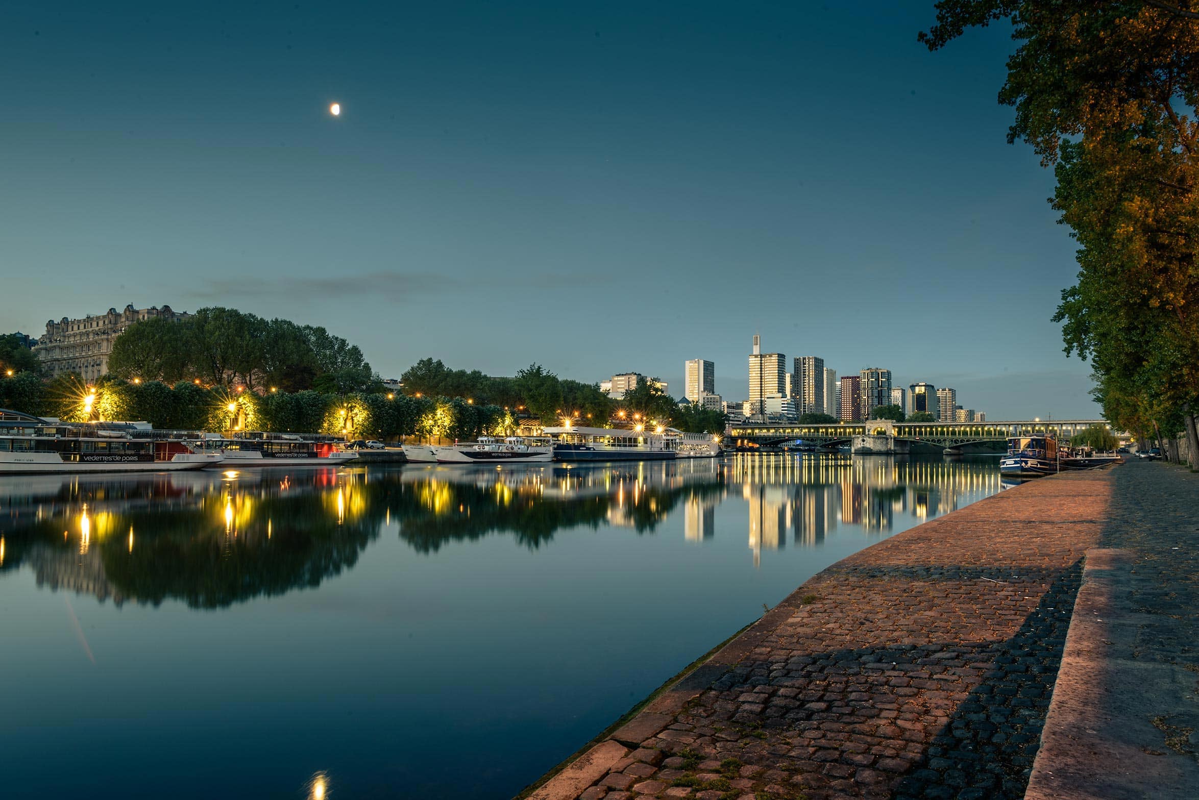 A river in paris at dusk.