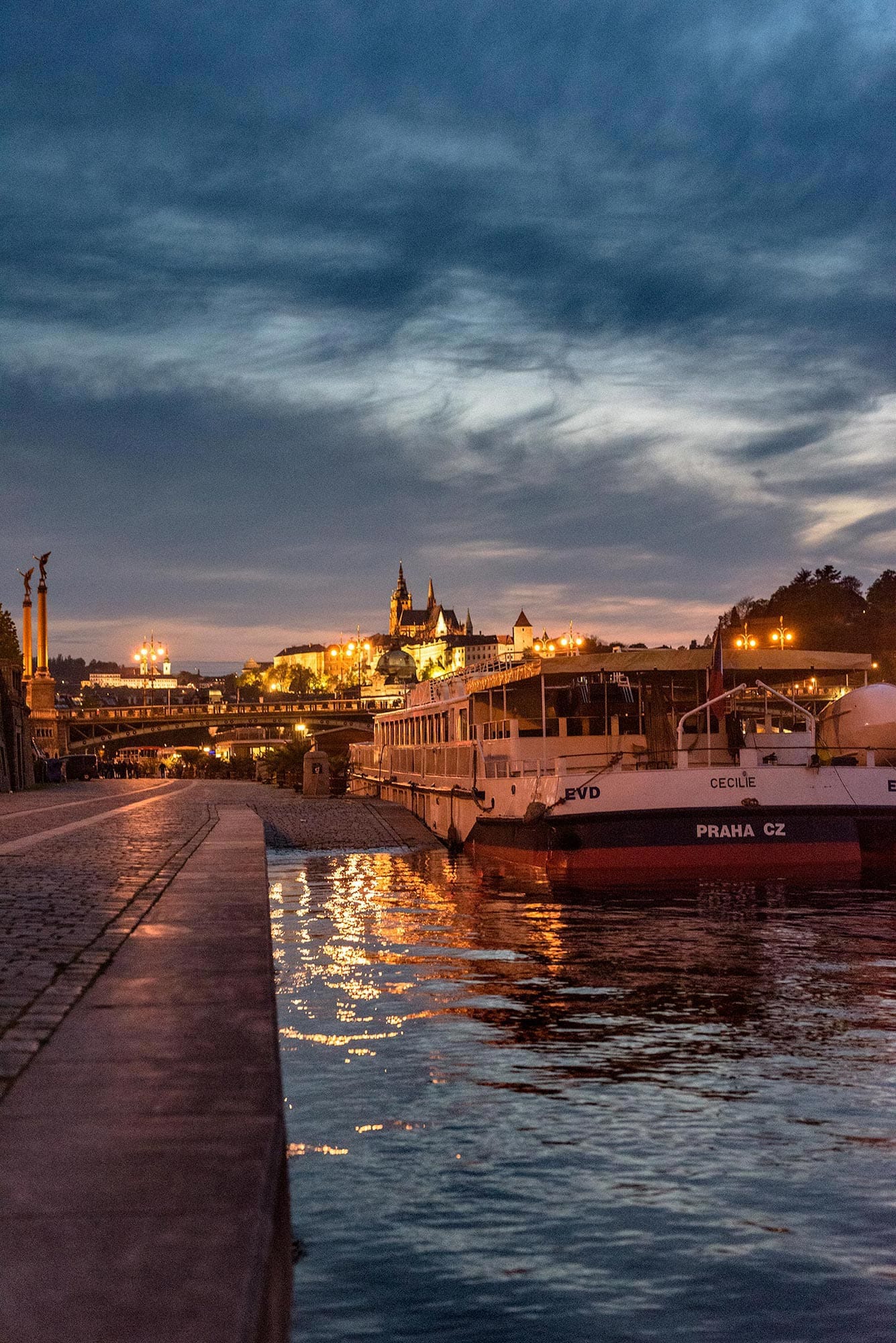 A boat docked on a river at dusk.