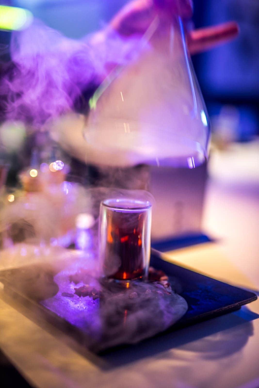 A person pouring liquid into a glass.