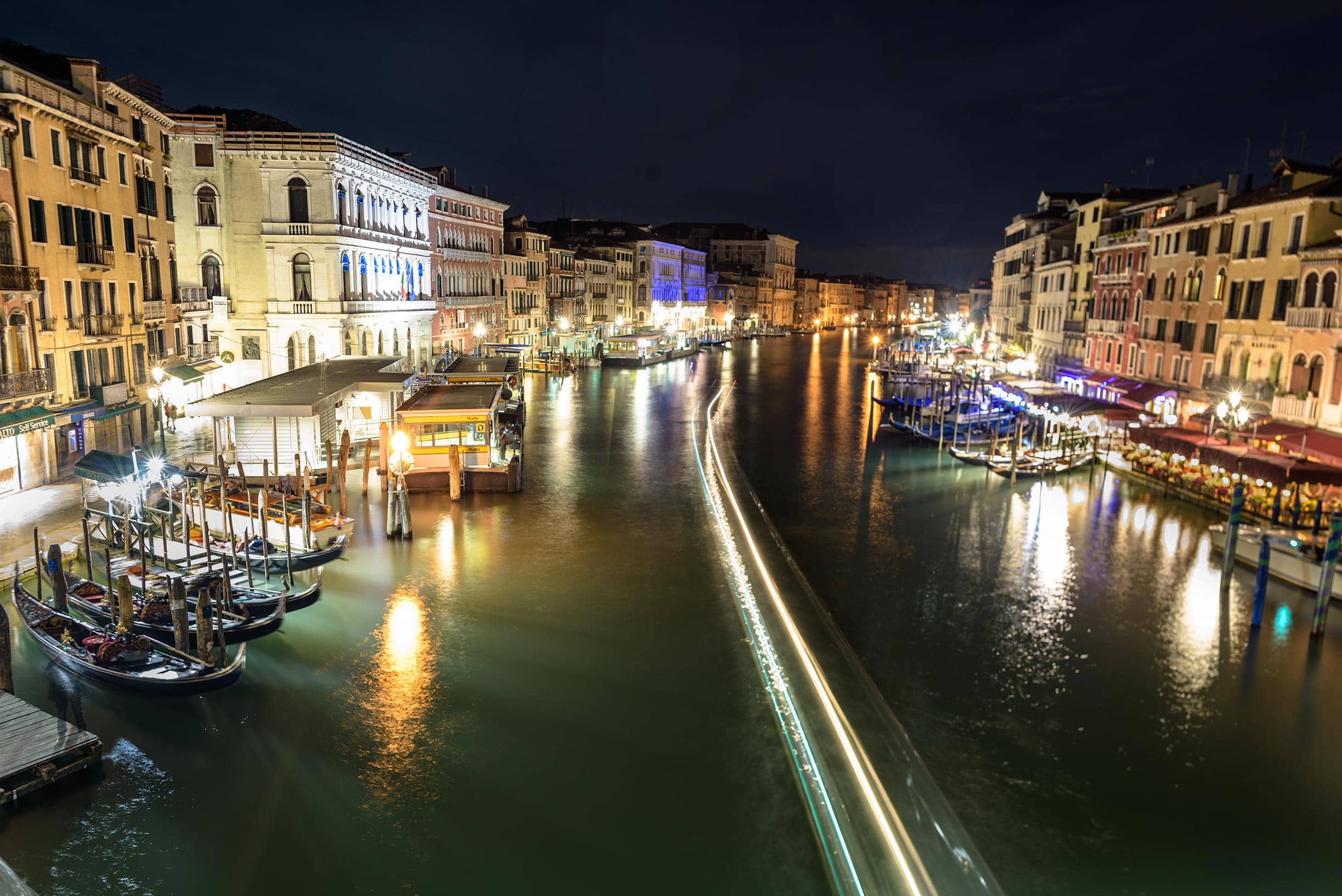 A canal in venice, italy at night.