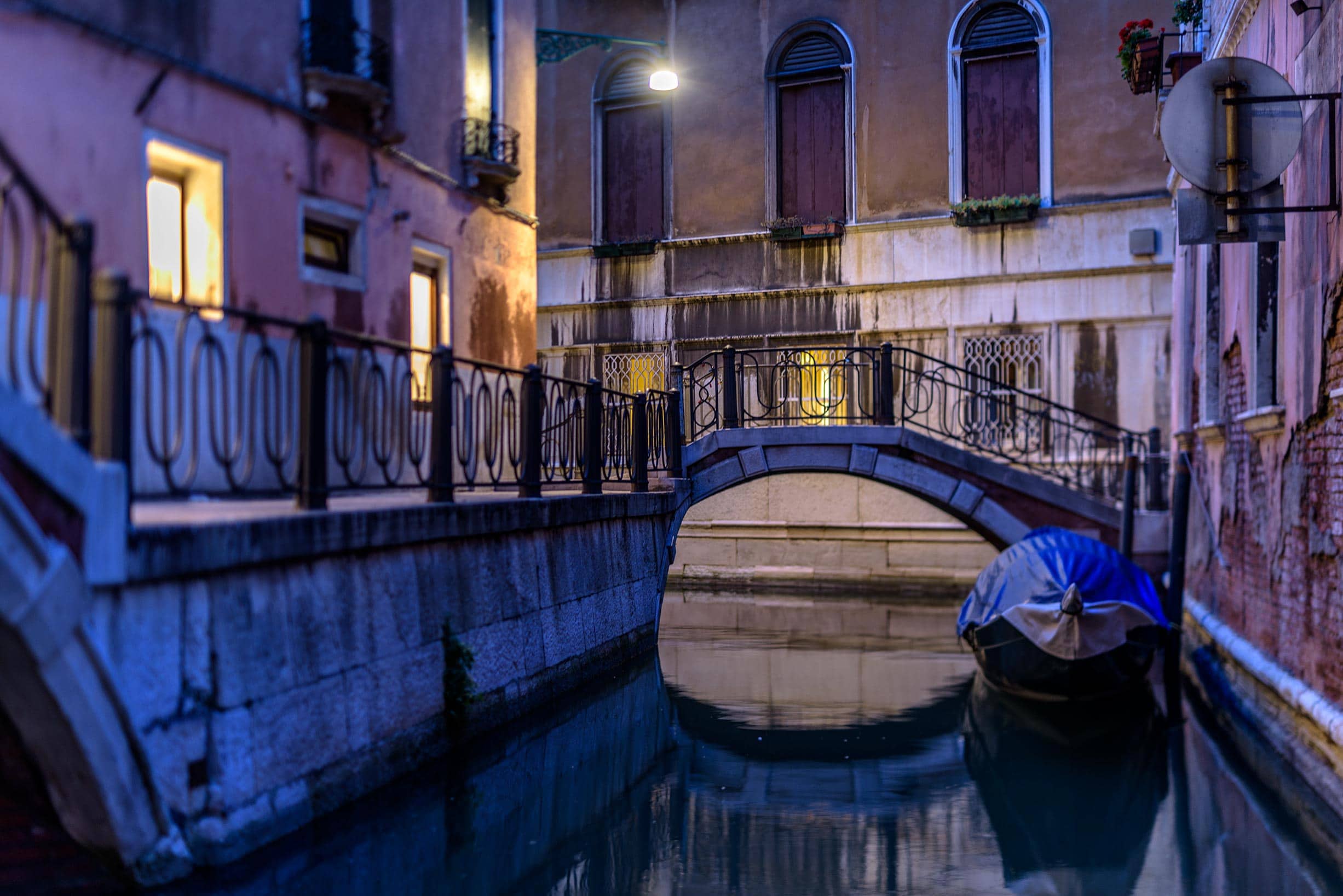 A gondola docked in a canal in venice, italy.