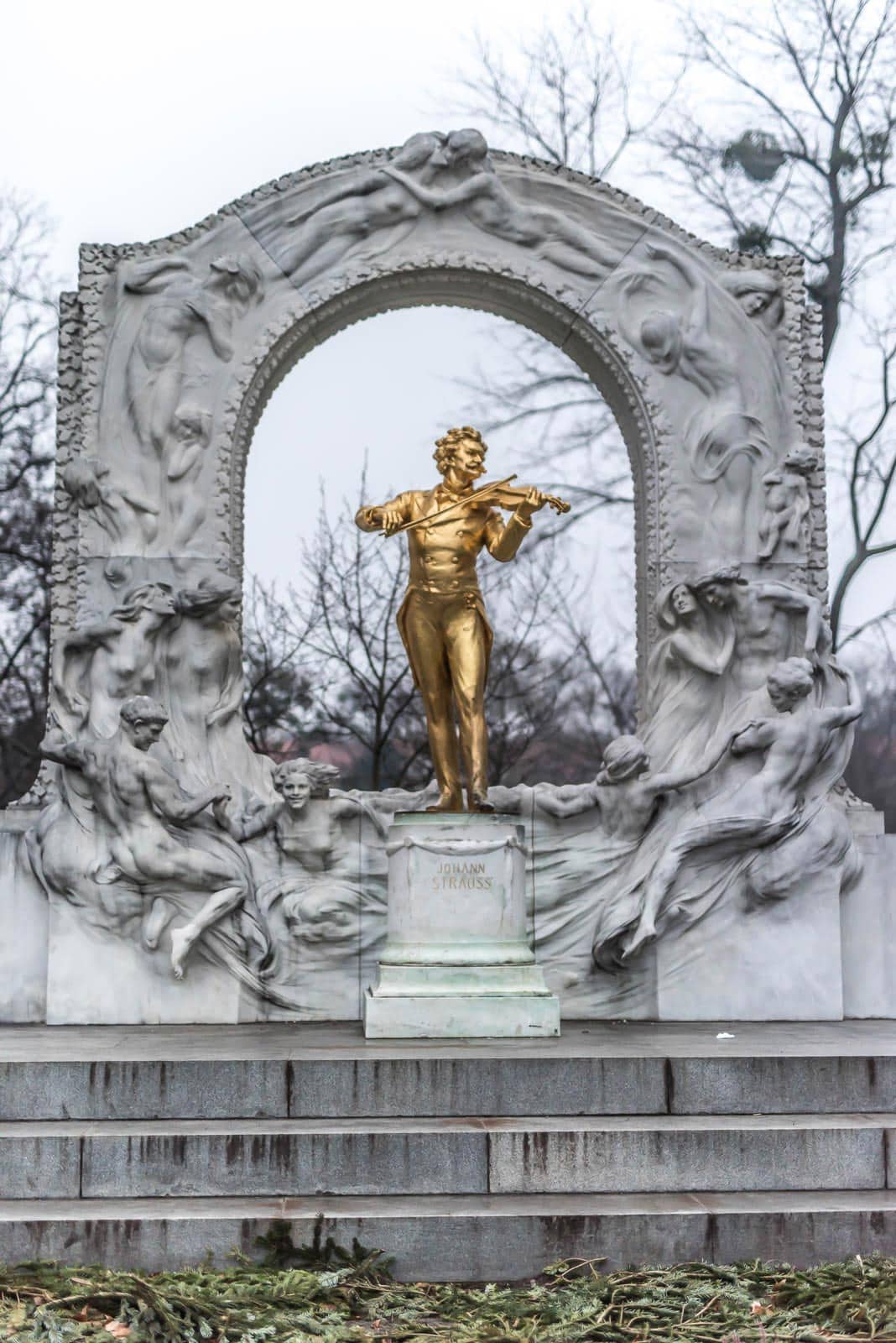 A statue of a golden statue in a park.