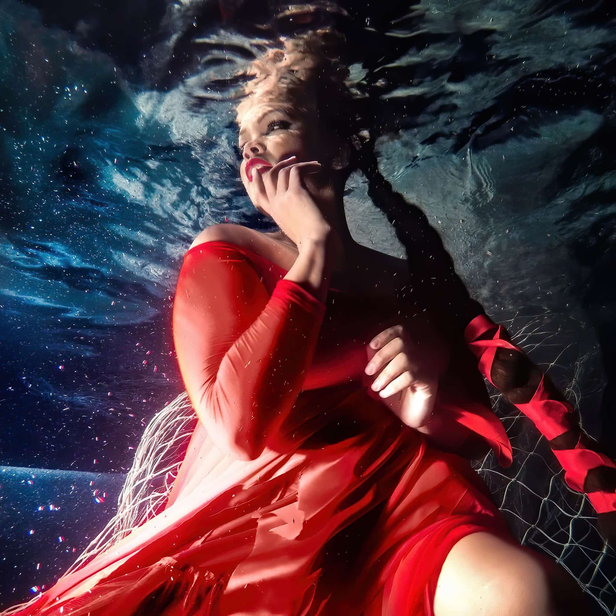 Bubbly model red dress  underwater 