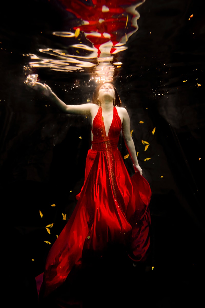 A woman in a red dress, captured through the lens of Creative Photography by Chris Spicks, a talented Houston Photographer.