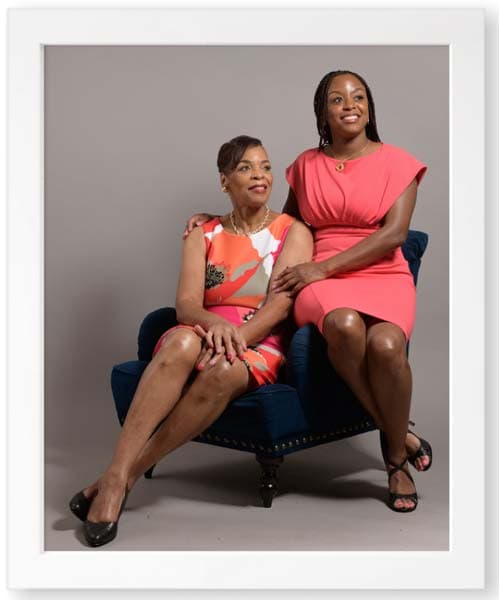 Two women posing for a photo in a gray frame by Chris Spicks Photography