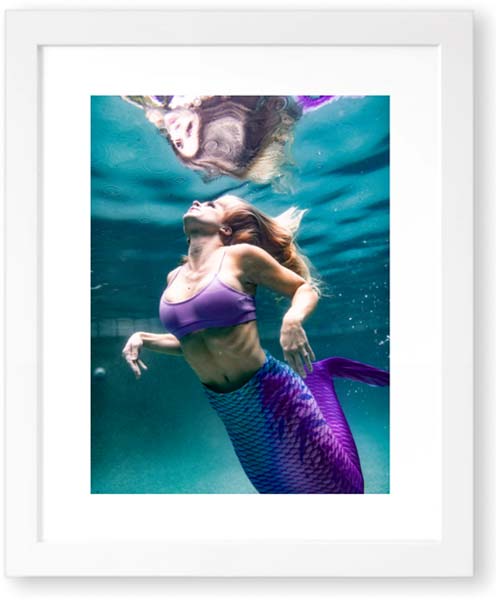 A creative photography of a mermaid wearing a purple swimsuit displayed in a white frame captured by Chris Spicks Photography, Houston Photographer.
