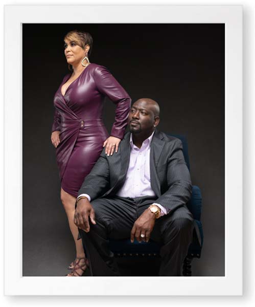 A man and woman in a creative photography session, wearing matching purple dresses, striking a pose for the camera.