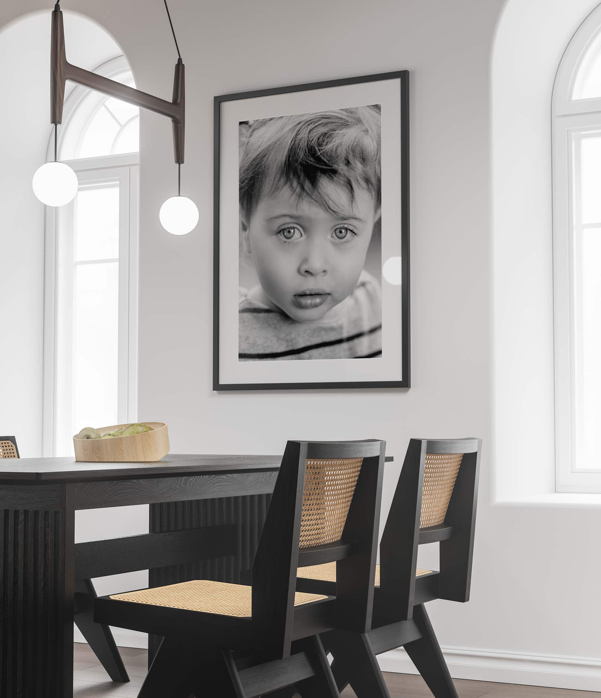 Up close portrait of a child's eyes, framed on a kitchen wall