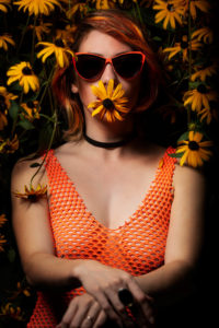 redhead model wearing bodysuit and glasses