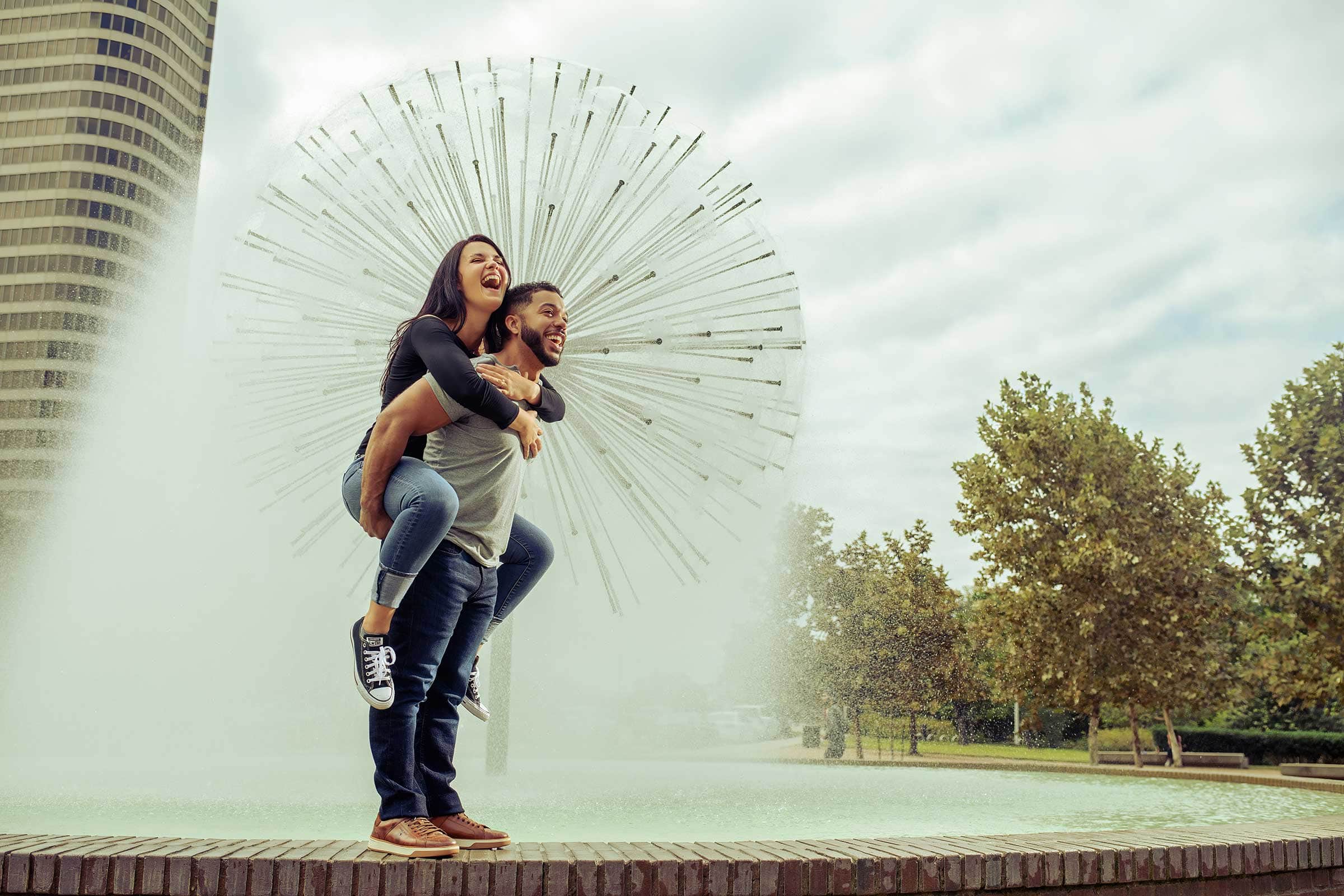 Chris Spicks Photography captures a heartfelt moment between a man and woman embracing in front of a fountain. With an artistic eye and years of experience, this Houston Photographer beautifully showcases the emotions through creative