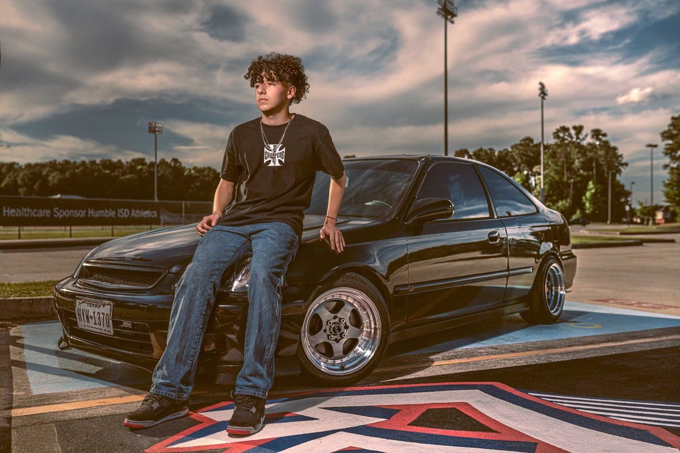 Chris Spicks Photography captures a young man in front of a black car with his creative and unique approach as a Houston photographer.