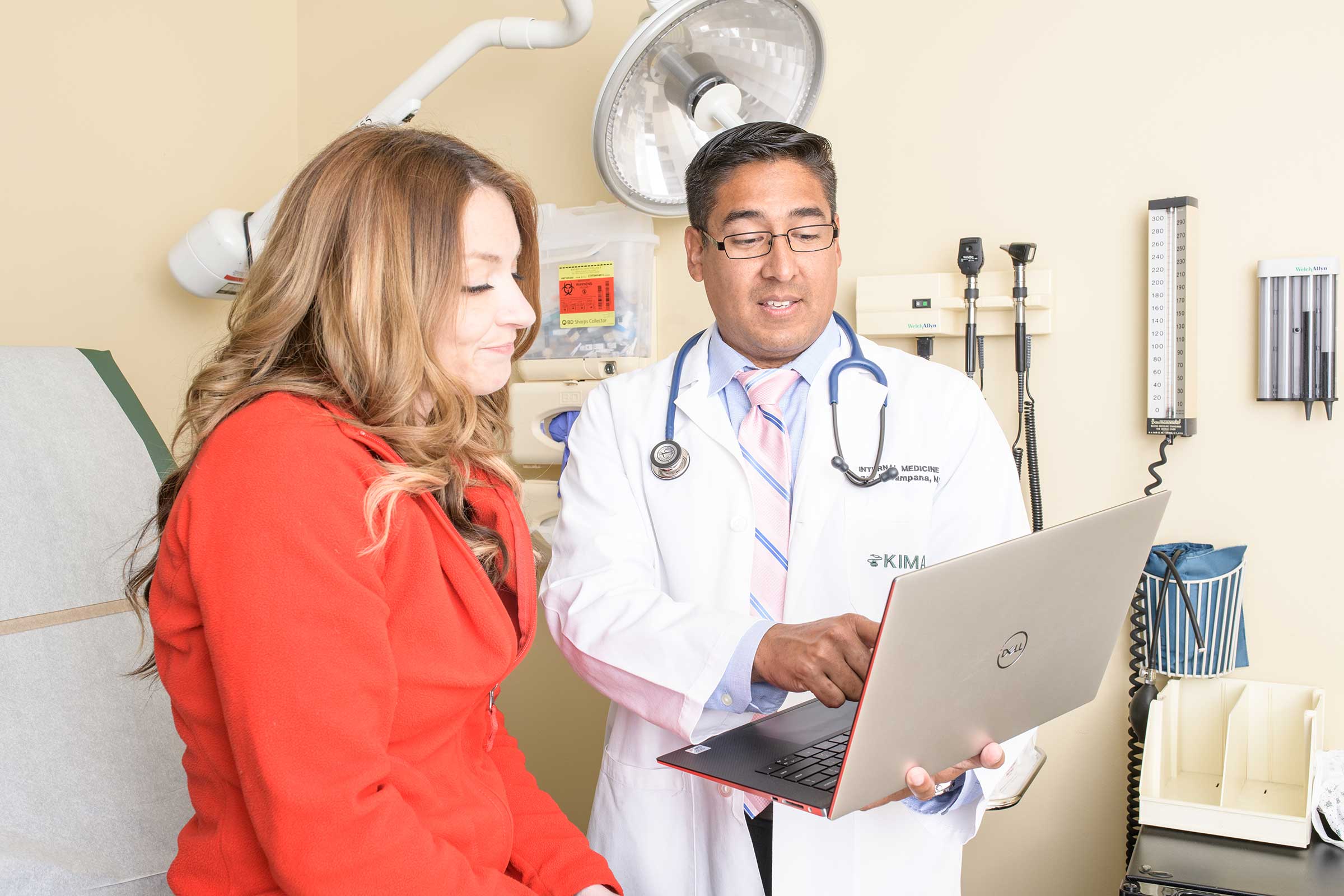 A man and a woman in a doctor's office captured by Houston Photographer, Chris Spicks Photography, showcasing creative photography.