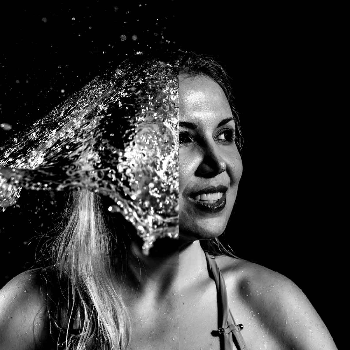 A black and white photo of a woman splashed with water captured by Houston Photographer, Chris Spicks Photography.