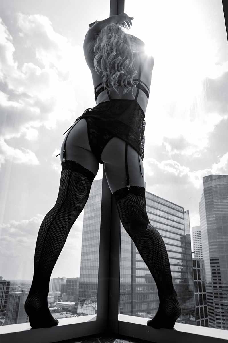 A black and white photo of a sexy woman in stockings captured by Houston Photographer, Chris Spicks Photography.