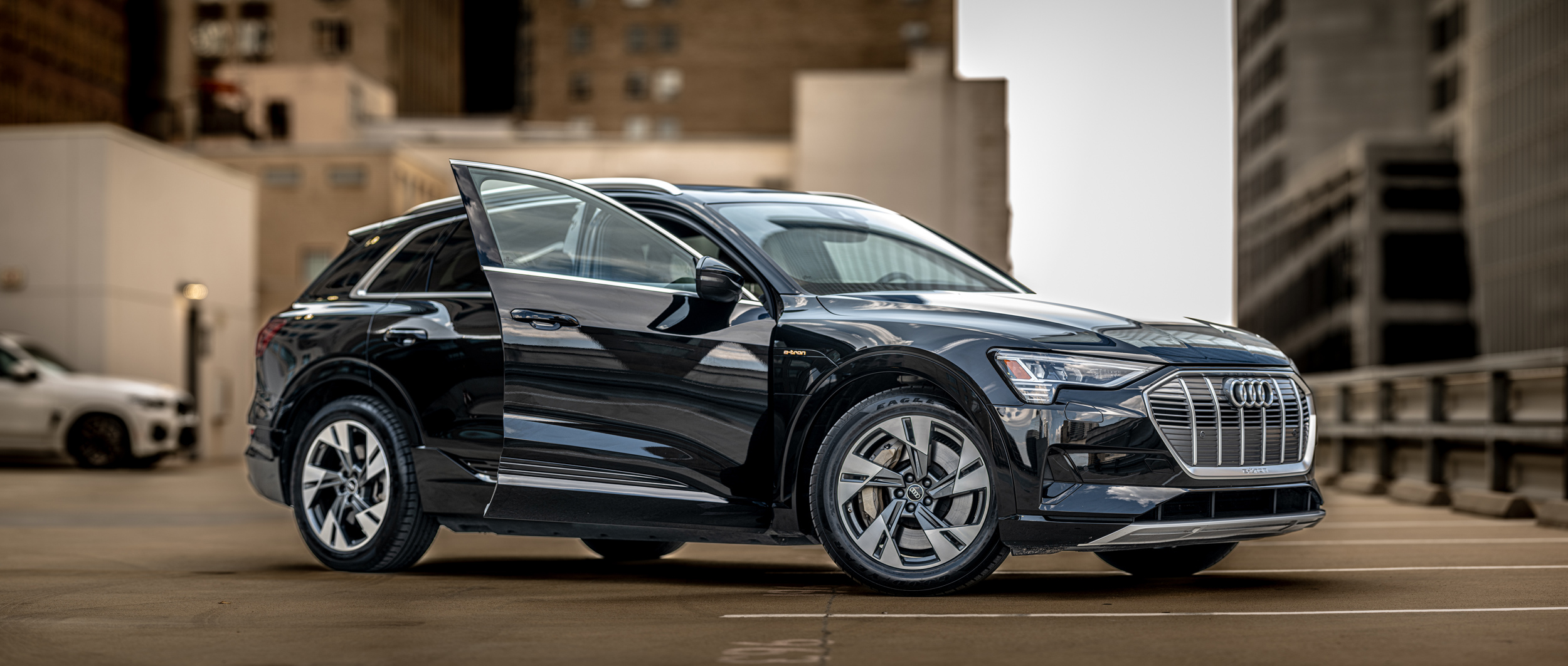 The 2020 Audi Q5 is parked in a parking lot in Houston.